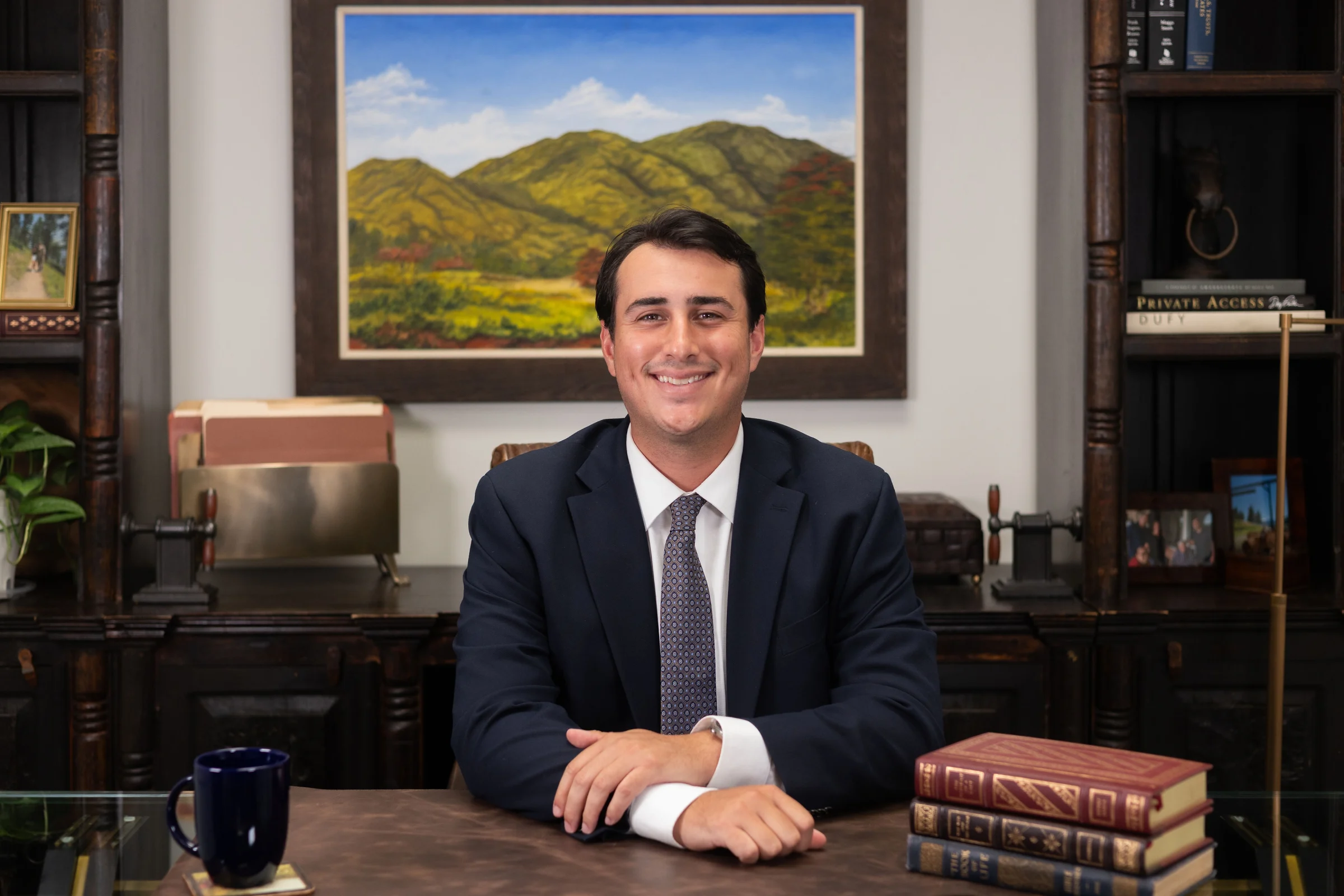 Attorney Andres Vega seated at his desk in his Miami Lakes office